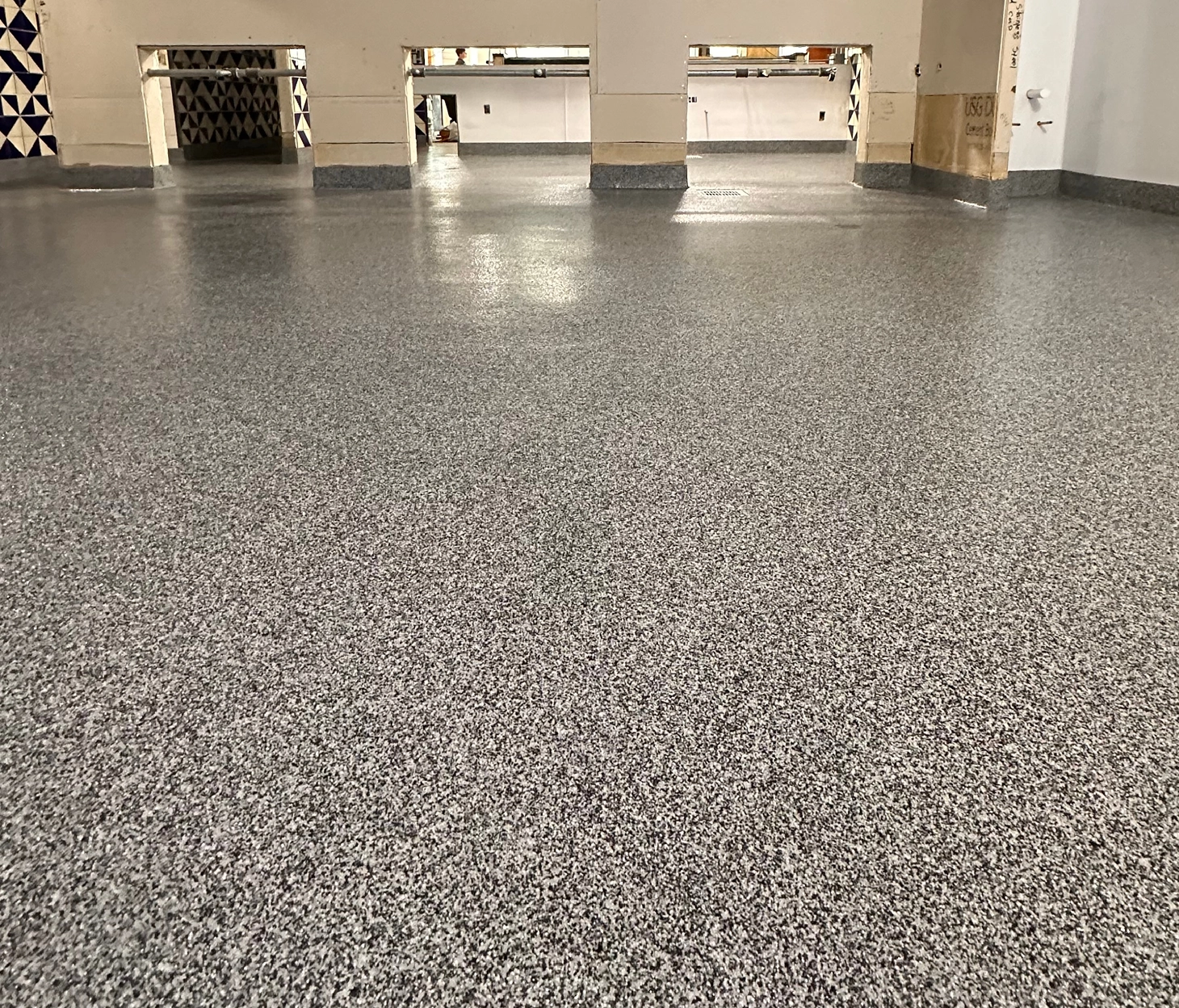 Urethane cement flooring with cove base and cutout wall openings in a commercial kitchen