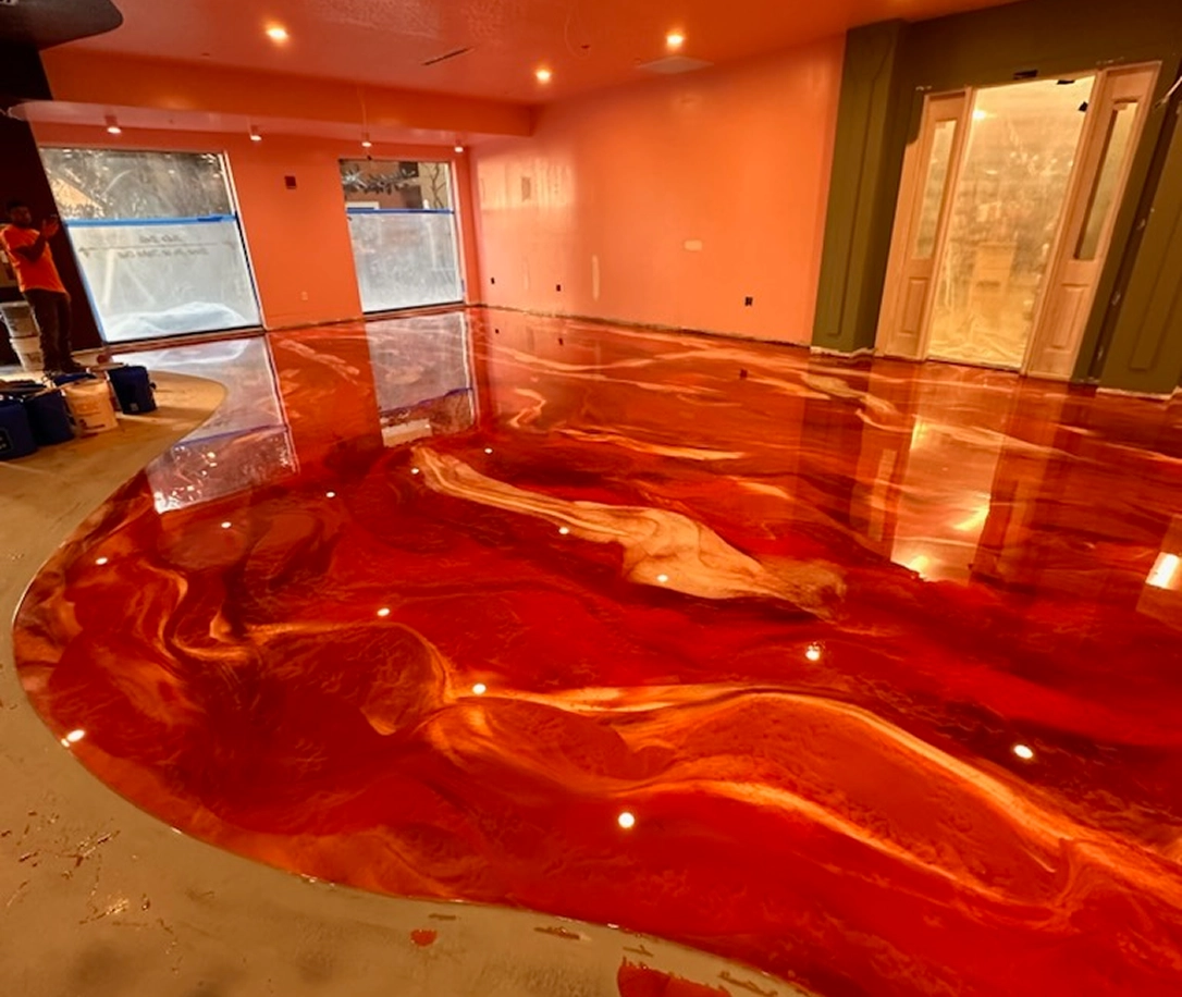 High-gloss red epoxy resin floor with marbled finish in modern residential interior